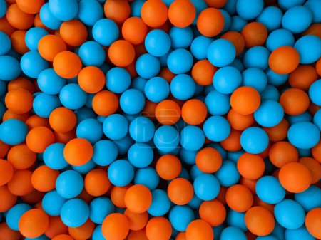 Photo for Blue and orange balls in a children's ball pool. Background. Example of the complementary colours blue and orange. - Royalty Free Image
