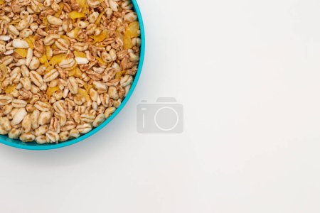 Photo for Top view with copy space of a bowl of unsweetened puffed wheat corn cereal. Healthy food. Vegan breakfast. - Royalty Free Image