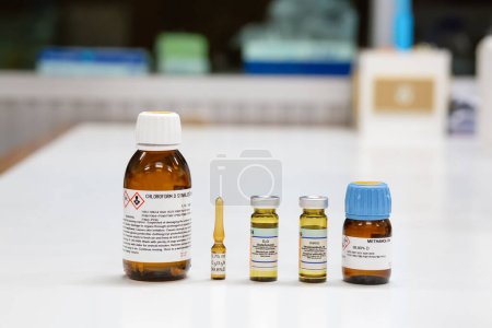 Photo for Glass bottles of NMR solvent, chloroform, pyridine, D2O, DMSO, and methanol. The NMR Solvents are used to dissolve samples to prepare solutions for analysis by the NMR spectroscopy method. - Royalty Free Image