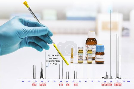 Photo for The hand of the scientist shows the yellow sample solution, and the NMR spectrum of the sample was analyzed by the NMR spectroscopy method in chloroform. NMR solvent glass bottles, chloroform, pyridine, DMSO, D2O, and methanol. - Royalty Free Image