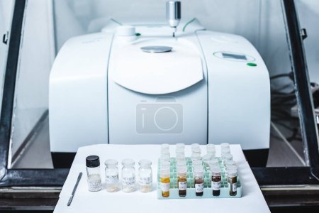 Photo for Fourier Transform Infrared Spectroscopy FTIR Instrument and sample in vials for analysis. The FTIR instrument was used to identify the chemical identity of the drug or sample analysed. The FTIR is used in industry and other research. - Royalty Free Image
