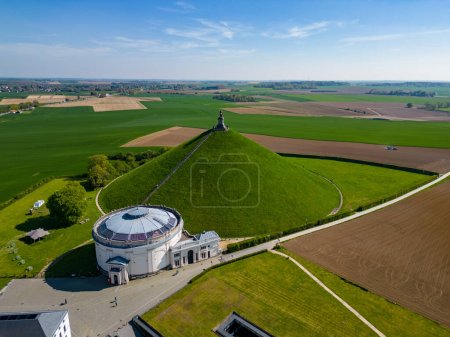 Aerial view farm field, Lions Mound, Battle field, Napoleon, Waterloo, Belgium, green and sky, season. Aerial View at the Waterloo Hill with the statue of the lion of Memorial Battle of Waterloo