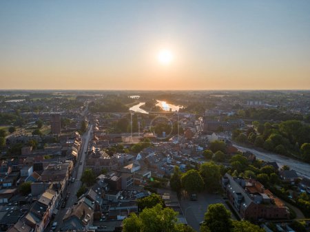 Photo for Duffel, Antwerp, Belgium, 22nd of June, 2023, Aerial view of the town or village of Duffel, in the Antwerp area aerial photo showing the houses and streets of the village during sunrise. High quality - Royalty Free Image
