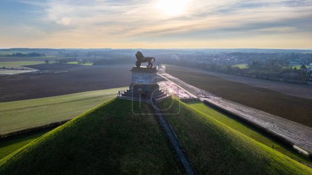 Photo for Waterloo, Brussels, Belgium, February 25th, 2024, The photograph presents a tranquil dusk scene at the Lions Mound, part of the Waterloo Battlefield memorial. The lion statue stands resolute atop the - Royalty Free Image