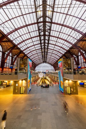 Photo for Antwerp, Belgium, January 25th, 2024, This image captures the symmetrical elegance of Antwerp Central Stations main concourse. Viewers can observe the grand scale of the arched iron and glass ceiling - Royalty Free Image