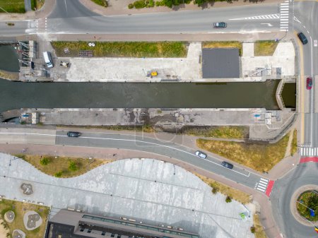 Photo for The birds-eye view in this photograph captures the intersection of urban infrastructure where roadways and a waterway converge. The composition is a study in geometry and organization, showcasing the - Royalty Free Image