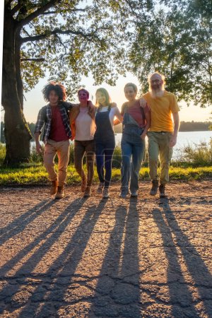 This image captures the relaxed essence of a family taking a stroll in the soft, diminishing light of the evening. The group is diverse, featuring individuals of various ages and ethnic backgrounds