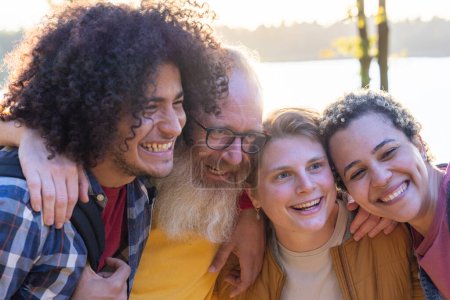 This heartwarming image captures a close-knit group of friends sharing a laugh together. The composition includes a diverse mix of individuals, including a young man with curly hair, an older man with