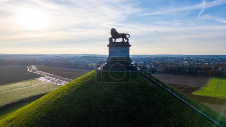 Photo for Waterloo, Brussels, Belgium, February 25th, 2024, The image depicts the Lions Mound at the Waterloo battlefield memorial, captured during the soft light of sunrise. The lion statue is silhouetted - Royalty Free Image