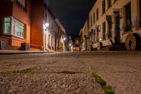 This image captures the essence of a late evening in Lillo, Antwerp, with the cameras low perspective emphasizing the cobblestone texture. The historic towns charm is illuminated under the soft glow