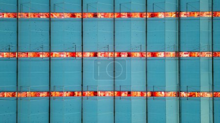 A close-up on the vibrant LED grow lights illuminating the interior of a high-tech greenhouse. The rhythmic pattern of the lights against the blue panels demonstrates the intersection of agriculture