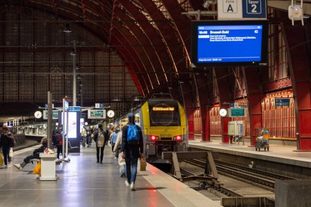 Photo for Antwerp, Belgium, January 25th, 2024, This image captures the essence of the evening rush hour at Antwerp Central Station with passengers heading towards the train destined for Brussels-Zuid. The - Royalty Free Image