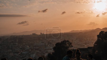 Photo for Distant view of historic famous Malaga Cathedral surrounded with cityscape against sky during sunset at Malaga in Andalusia, Spain - Royalty Free Image