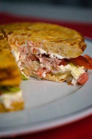 Indulge in the culinary excellence of a vegetable Spanish omelette served with a velvety white sauce, meticulously crafted in a gourmet restaurant. This omelette masterpiece is a symphony of flavors and textures, with each bite revealing the perfect 