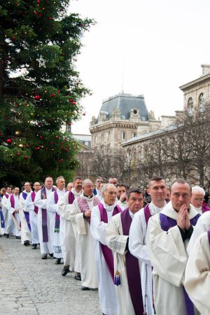 Téléchargez les photos : De nombreux prêtres entrent dans l "église Notre Dame de Paris - en image libre de droit