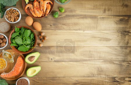 Photo for Selection of Omega-3 rich food sources on wooden background. Directly above, copy space. - Royalty Free Image