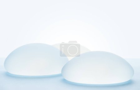 Breast implants on blue background.