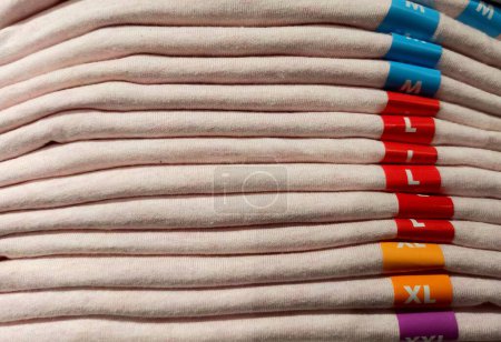 Foto de Ropa de algodón de diferentes tamaños plegada y apilada - Imagen libre de derechos