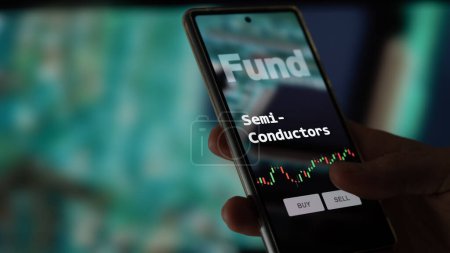 Photo for An investor's analyzing the semi-conductors etf fund on a screen. A phone shows the prices of semiconductor fund. - Royalty Free Image