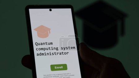 Photo for 28th August 2023. A student holds a phone, enrolls in courses to study quantum computing system administrator program, learn new skill and pass certification. Text in English, English text. - Royalty Free Image