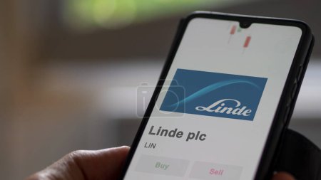 Photo for The logo of Linde plc on the screen of an exchange. Linde plc price stocks, $LIN on a device. - Royalty Free Image