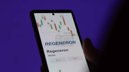 Photo for The logo of Regeneron on the screen of an exchange. Regeneron price stocks, $REGN on a device. - Royalty Free Image