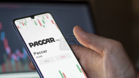 Photo for The logo of Paccar on the screen of an exchange. Paccar price stocks, $PCAR on a device. - Royalty Free Image
