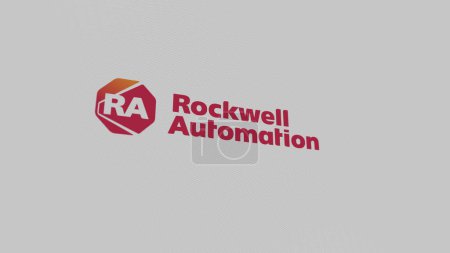 Foto de El logotipo de Rockwell Automation en una pared blanca de pantallas. Marca Rockwell Automation en un dispositivo. - Imagen libre de derechos