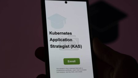 Photo for A student enrolls in courses to study kubernetes application strategist (kas) program, learn new skill and pass certification, on a phone. Text in English, English text. - Royalty Free Image