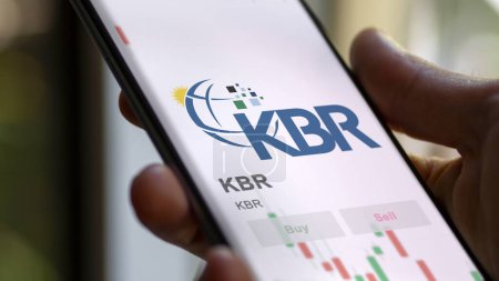 Photo for November 15th 2023. The trading page of KBR on a stock exchange, a shareholder analyzing $KBR, , on a device. - Royalty Free Image