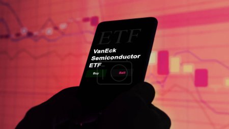 Photo for November 17th 2023. An investor analyzing on a phone an etf fund VanEck Semiconductor ETF. - Royalty Free Image