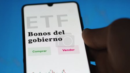 Photo for An investor analyzing an etf fund. ETF text in Spanish : government bonds, buy, sell. - Royalty Free Image