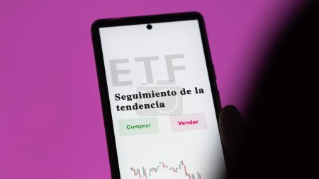 Photo for An investor analyzing an etf fund. ETF text in Spanish : trend-following, buy, sell. - Royalty Free Image