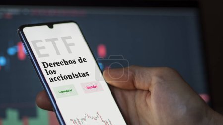 Photo for An investor analyzing an etf fund. ETF text in Spanish : shareholder rights, buy, sell. - Royalty Free Image