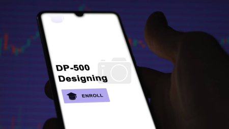 Photo for January 03th 2024. Student enrolls to DP-500 Designing program on a phone, upskilling certification by e-learning - Royalty Free Image