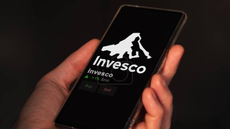 Photo for January 15th 2024. The logo of Invesco on the screen of an exchange. Invesco price stocks, $IVZ on a device. - Royalty Free Image