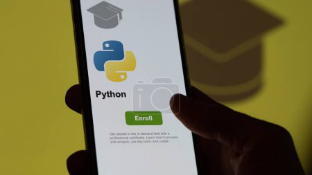 Photo for March 04th 2024. Student enrolls to Python program on a phone, upskilling certification by e-learning - Royalty Free Image