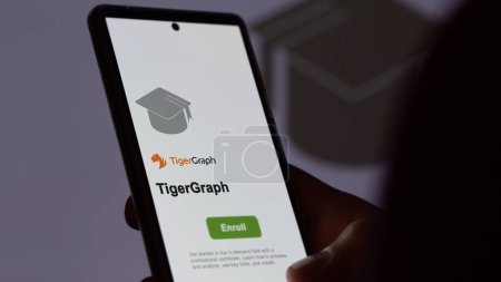 Photo for March 04th 2024. Student enrolls to TigerGraph program on a phone, upskilling certification by e-learning - Royalty Free Image