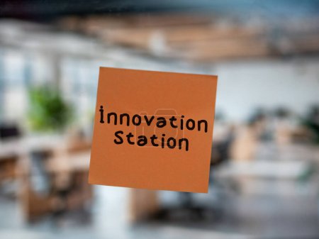 Post note on glass with 'Innovation Station'.