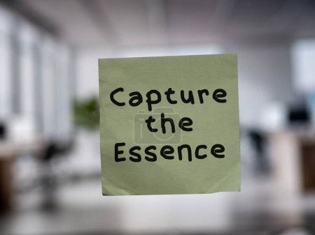 Post note on glass with 'Capture the Essence'.