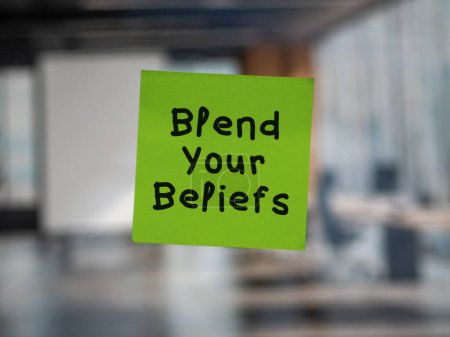 Post note on glass with 'Blend Your Beliefs'.