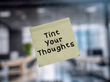 Post note on glass with 'Tint Your Thoughts'.