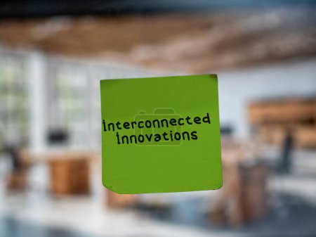 Photo for Post note on glass with 'Interconnected Innovations'. - Royalty Free Image