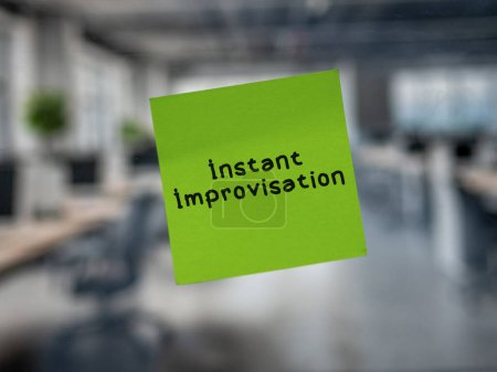Post note on glass with 'Instant Improvisation'.