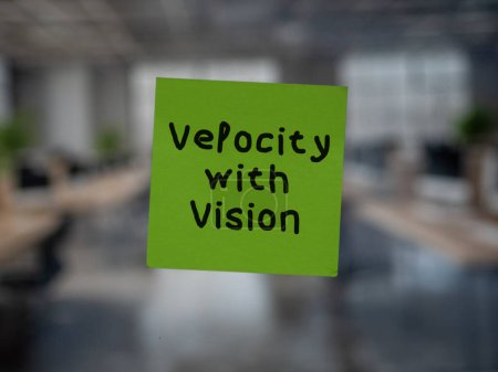 Post note on glass with 'Velocity with Vision'.