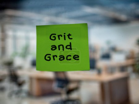 Post note on glass with 'Grit and Grace'.