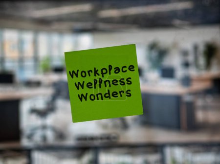 Post note on glass with 'Workplace Wellness Wonders'.