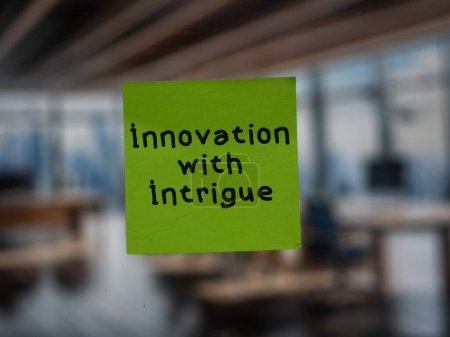 Post note on glass with 'Innovation with Intrigue'.