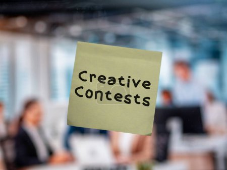 Post note on glass with 'Creative Contests'.