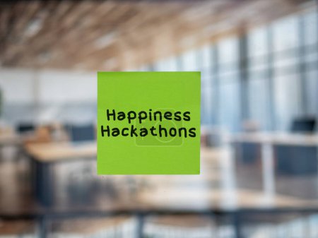 Post note on glass with 'Happiness Hackathons'.